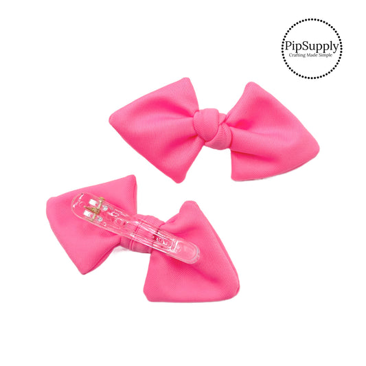 These bright pink swim bows have a two layer swimsuit fabric bow with edges that are securely folded and sewn providing a professional and high quality seam. Fabric is thick high quality not coarse or stiff and the pattern is visible on all sides. Bow comes pre-tied on a clear plastic clip.