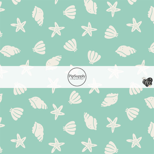 This beach fabric by the yard features seashells on light green. This fun themed fabric can be used for all your sewing and crafting needs!