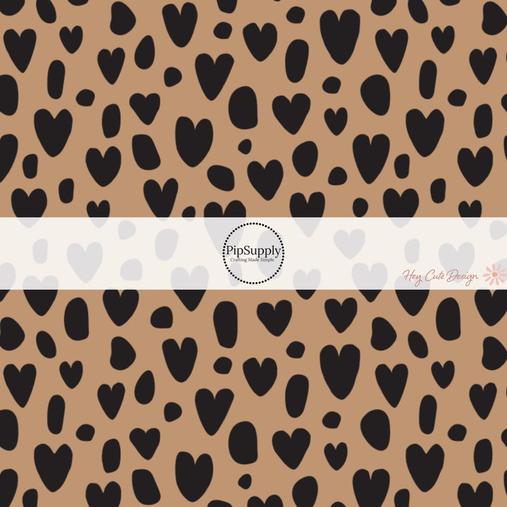 These heart and spot themed brown fabric by the yard features leopard pattern with hearts and spots in black on brown. This fun animal themed fabric can be used for all your sewing and crafting needs!
