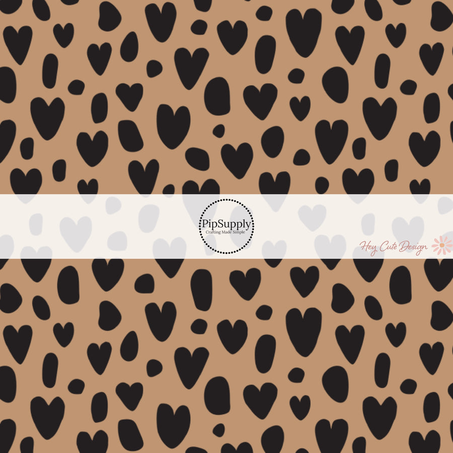These heart and spot themed brown fabric by the yard features leopard pattern with hearts and spots in black on brown. This fun animal themed fabric can be used for all your sewing and crafting needs!