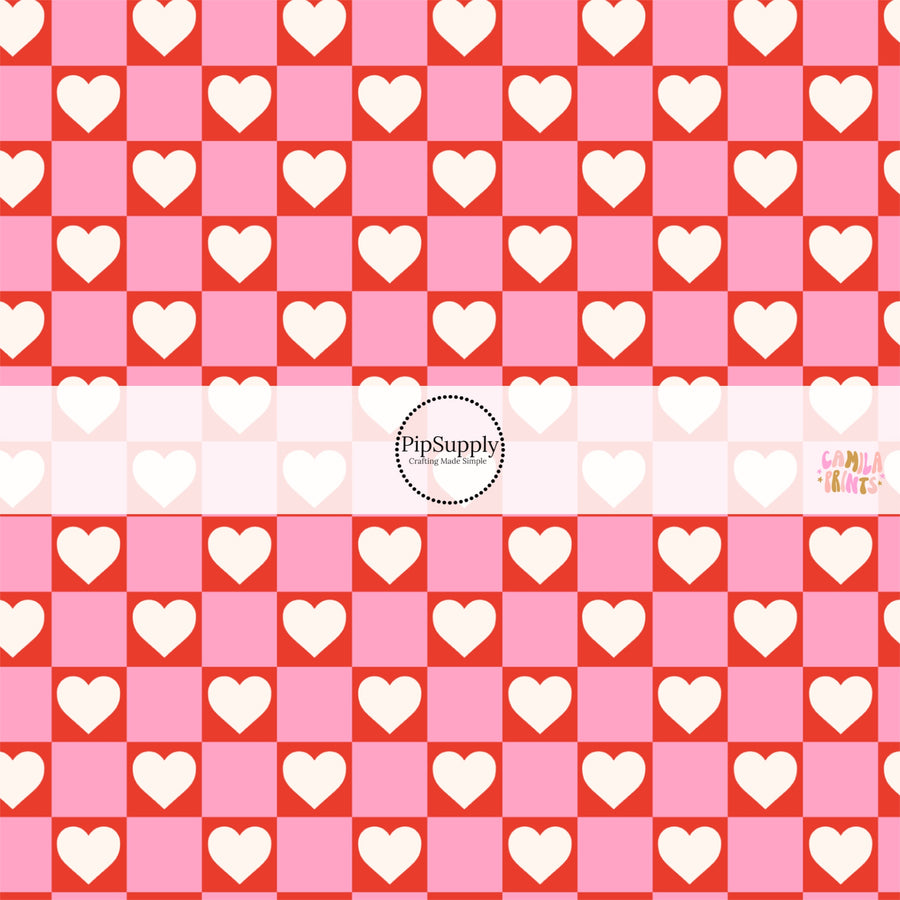 This holiday fabric by the yard features hearts on red and pink checkers. This festive pattern fabric can be used for all your sewing and crafting needs!