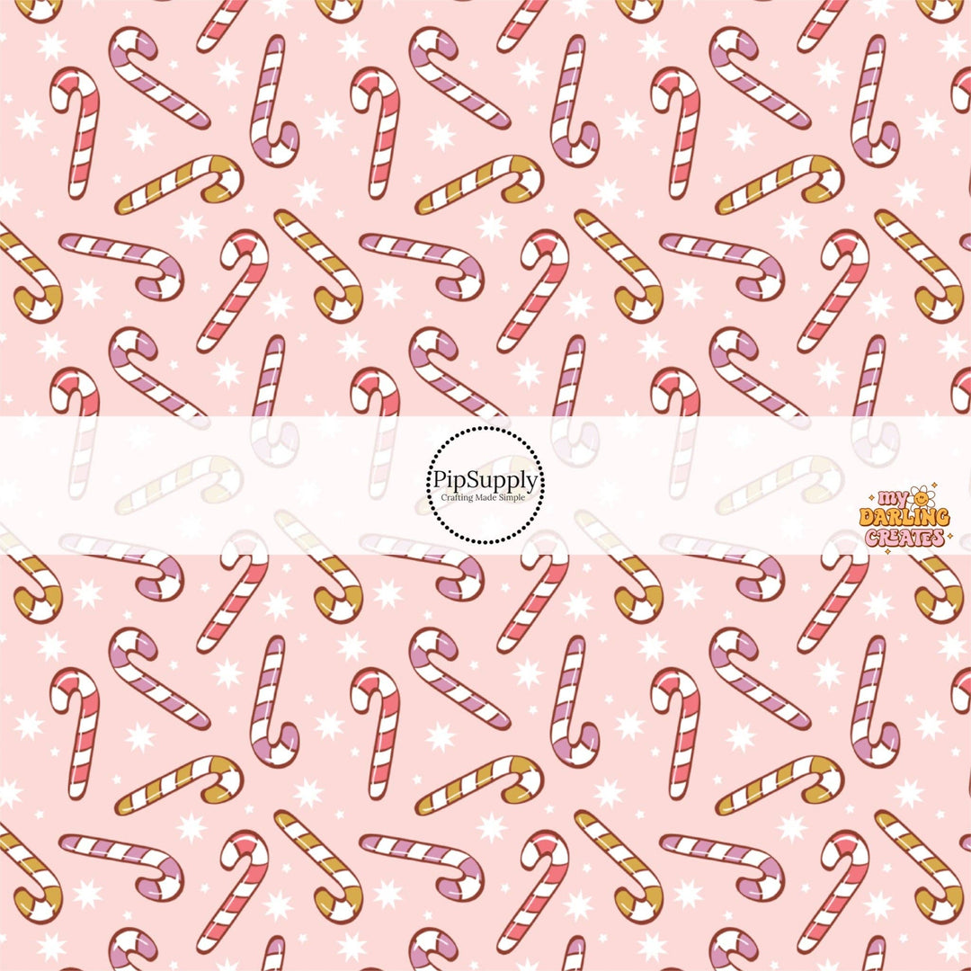 Assorted Candy Canes on Baby Pink Fabric By The Yard