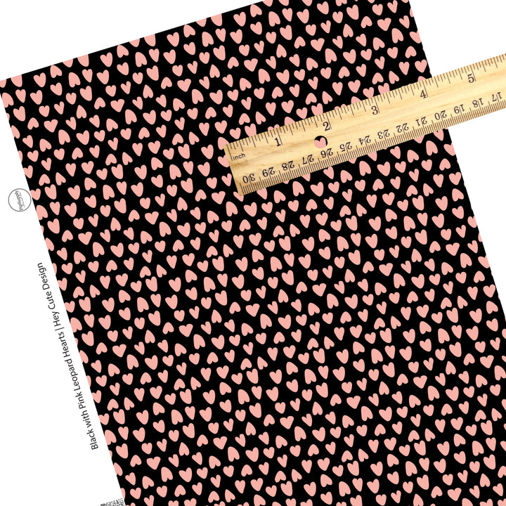 These heart and spot themed black faux leather sheets contain the following design elements: leopard pattern with hearts and spots in pink on black. Our CPSIA compliant faux leather sheets or rolls can be used for all types of crafting projects.