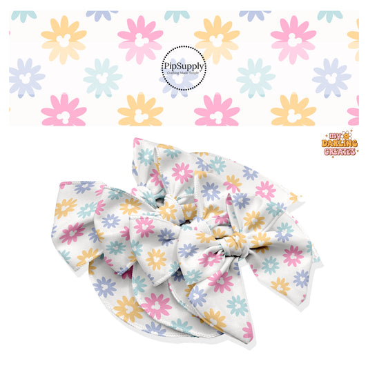 These magical inspired themed no sew bow strips can be easily tied and attached to a clip for a finished hair bow. These fun themed patterned bow strips are great for personal use or to sell. These bow strips feature the following multi colored daisies with mouse ears on cream.