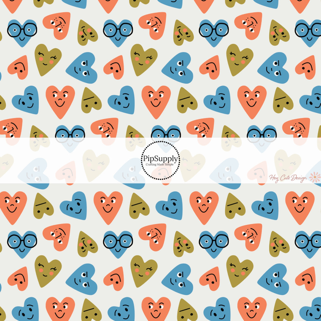 This holiday fabric by the yard features blue, orange, and green smiley hearts. This festive pattern fabric can be used for all your sewing and crafting needs!