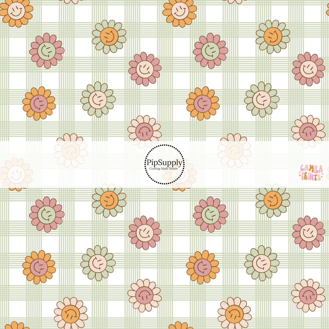 This spring fabric by the yard features smiley flowers on green and cream gingham. This fun pattern fabric can be used for all your sewing and crafting needs!