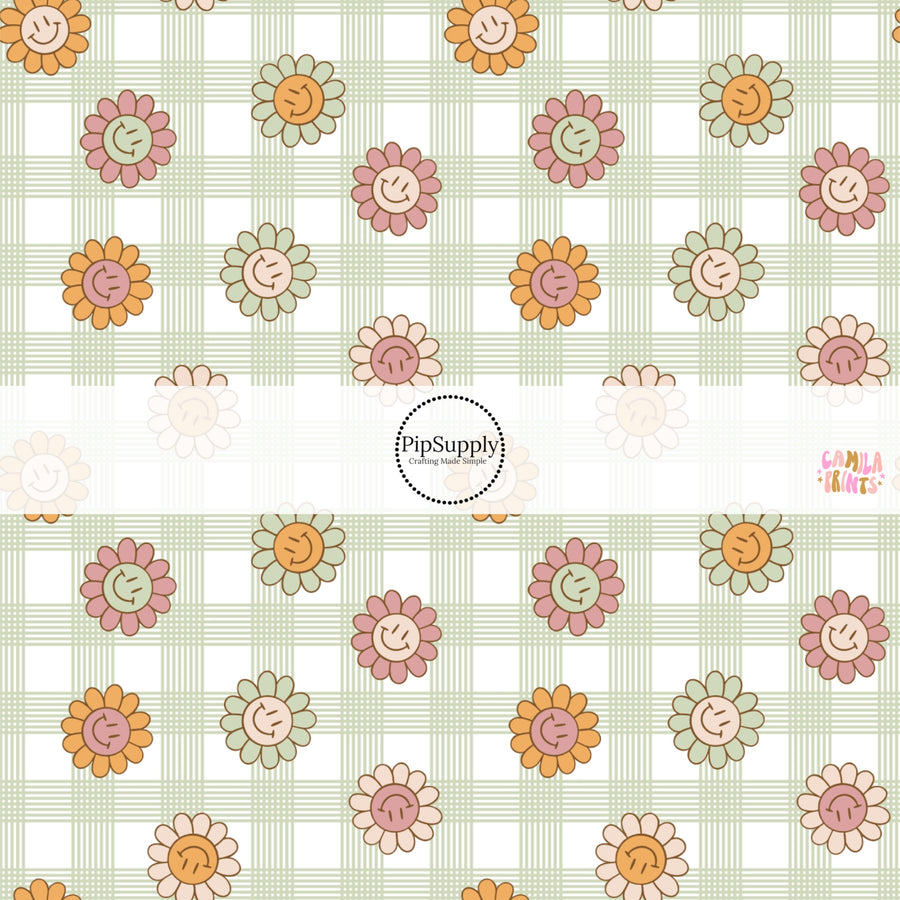 This spring fabric by the yard features smiley flowers on green and cream gingham. This fun pattern fabric can be used for all your sewing and crafting needs!