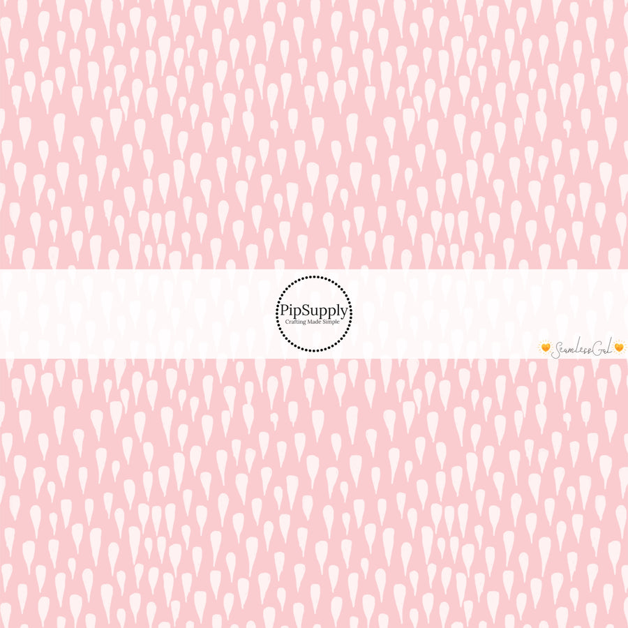 This spring themed fabric by the yard features drops on light pink. This fun pattern fabric can be used for all your sewing and crafting needs!