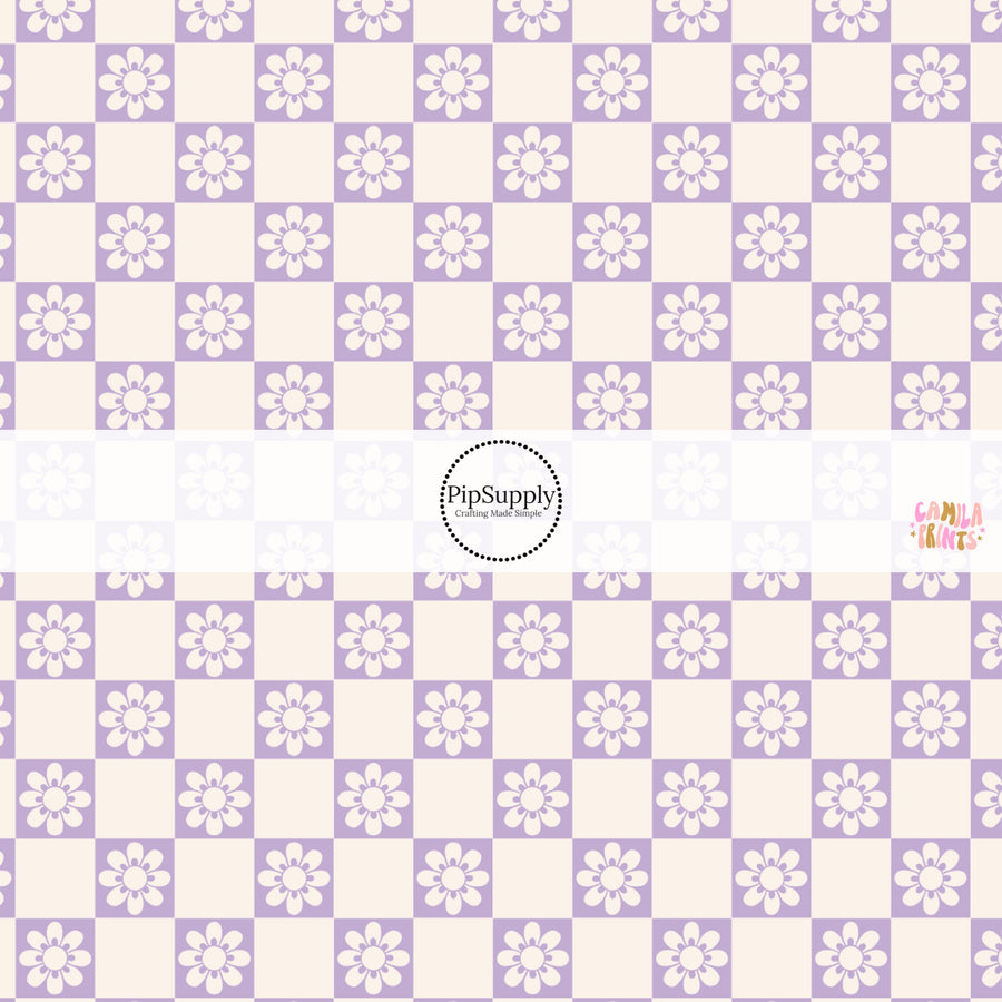 This spring fabric by the yard features daisy flowers on purple and cream checkers. This fun pattern fabric can be used for all your sewing and crafting needs!