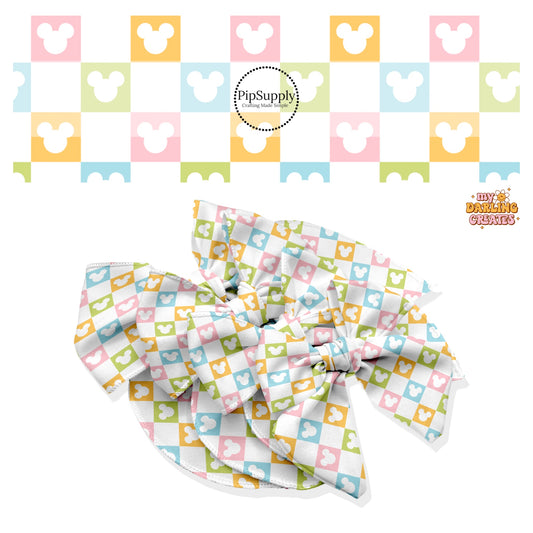 These magical inspired themed no sew bow strips can be easily tied and attached to a clip for a finished hair bow. These fun themed patterned bow strips are great for personal use or to sell. These bow strips feature the following multi colored checker pattern with mouse ears on cream.