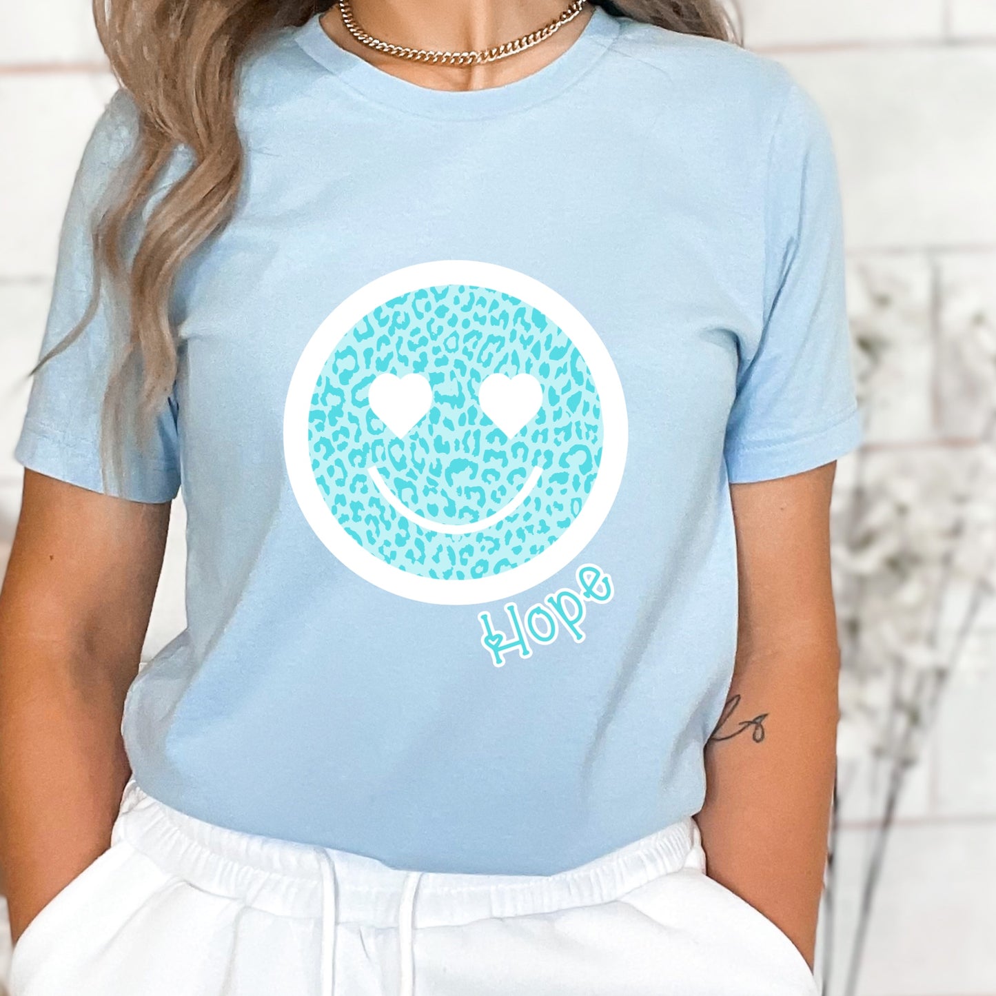 Blue leopard print smiley face with heart eyes and the word "Hope"