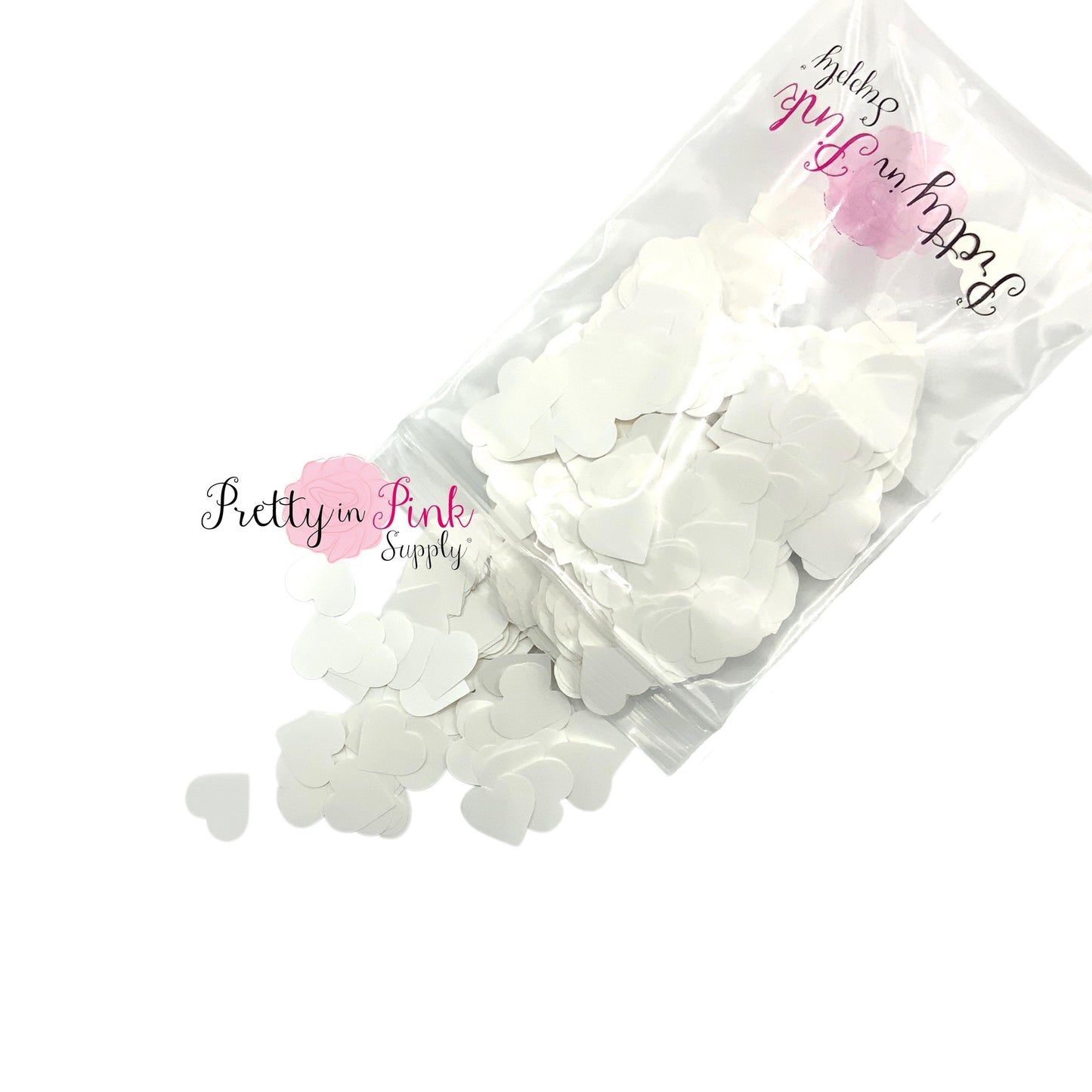 Spilling bag of white heart confetti glitter.