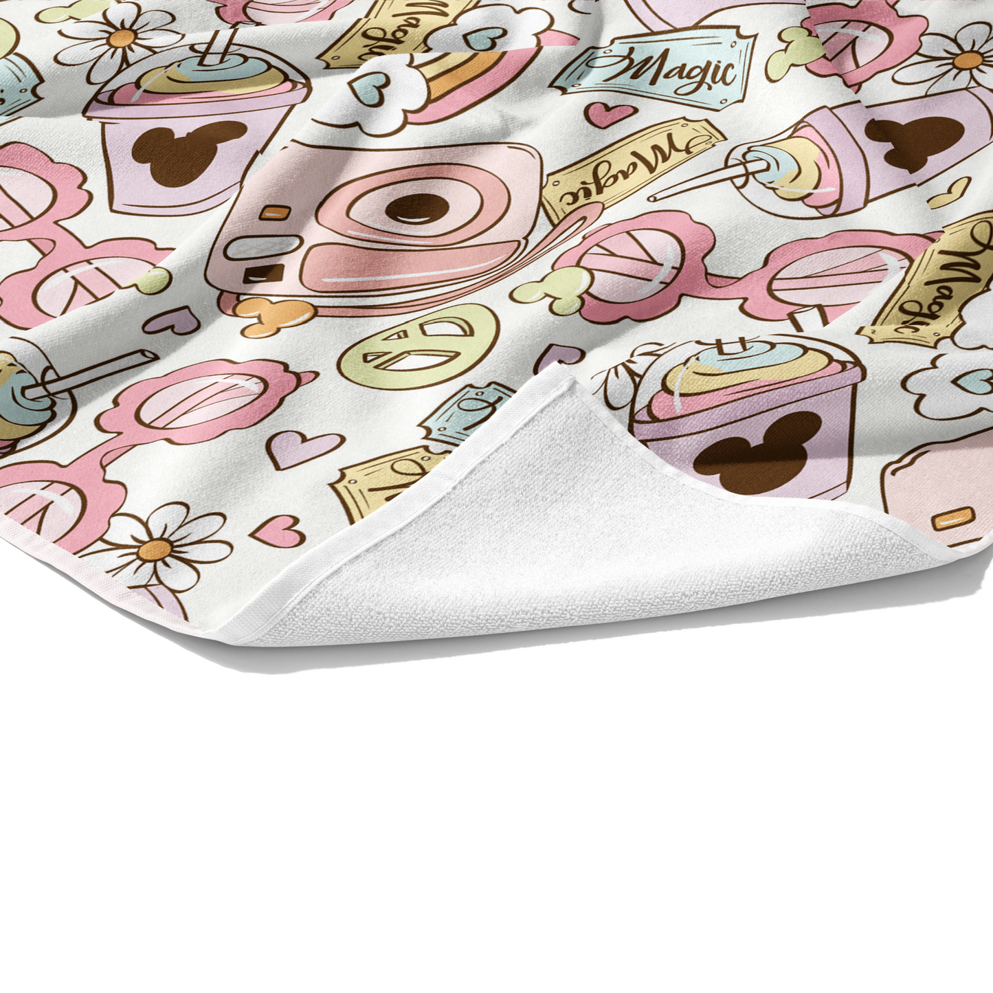 Plush towel with pastel pink mouse ear magic peace sign, hearts, and floral pattern on white.