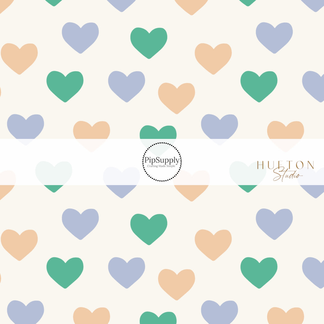 White Fabric by the yard pattern with yellow, blue, green hearts