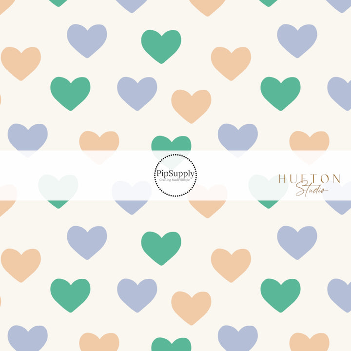 White Fabric by the yard pattern with yellow, blue, green hearts