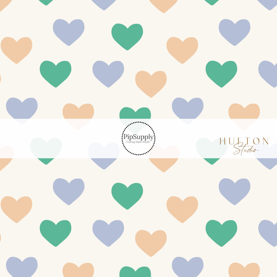 White Fabric by the yard pattern with yellow, blue, green hearts