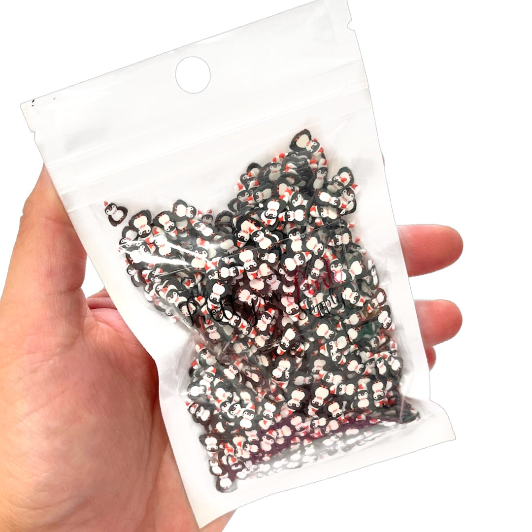 Bag of Christmas penguin polymer clay slices.