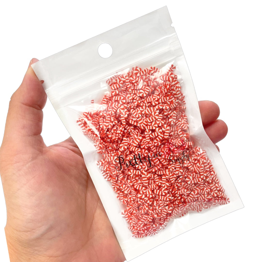 Bag of Christmasred and white candy cane polymer clay slices.