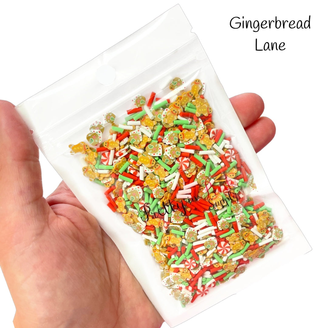 Bag with green, red, and white sprinkles, gingerbread man, gingerbread house, and red peppermints polymer clay slices mix.