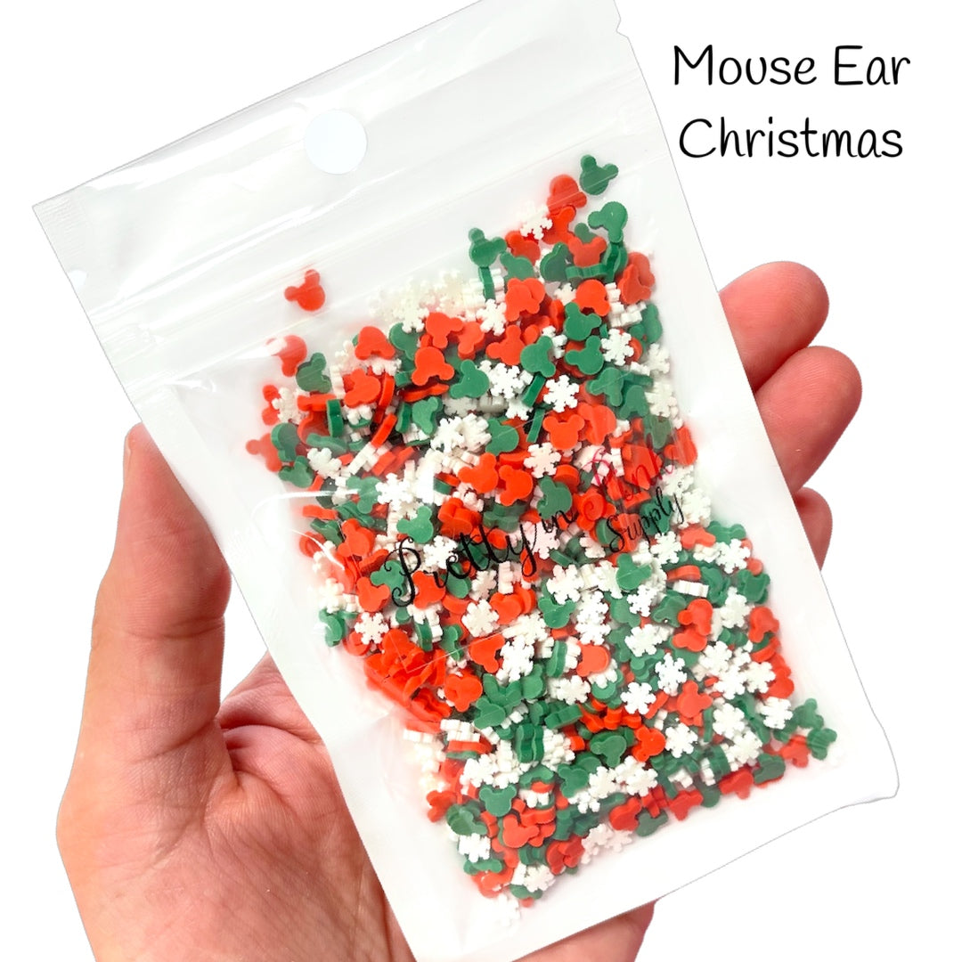 Bag with mix of red and green mouse ears and white snowflake polymer clay slices.