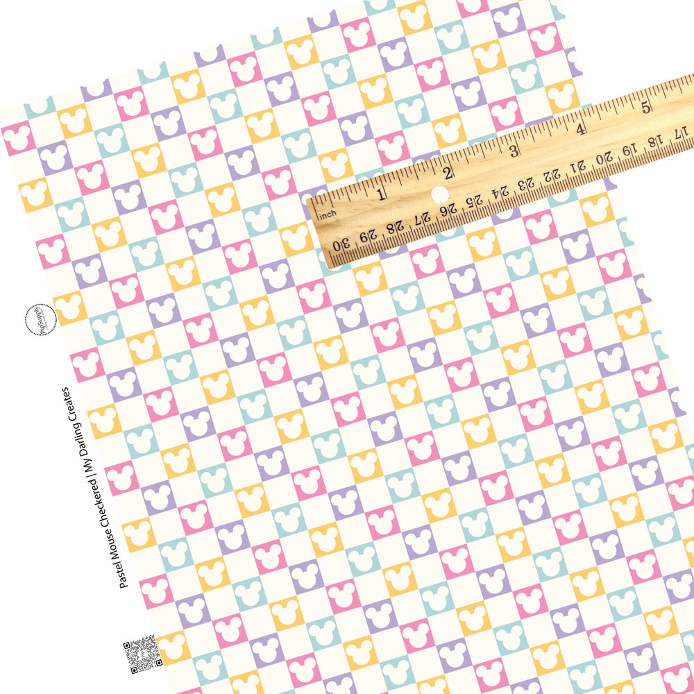 Cream mouse head cutout on pink, purple, yellow, and aqua checkered faux leather sheets