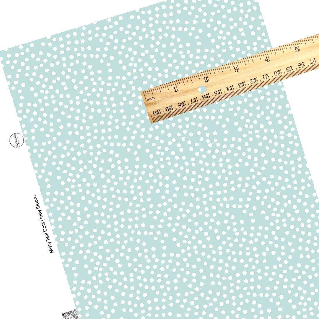 These small dots on a light teal faux leather sheets contain the following design elements: small dots in white scattered on a teal blue background.
