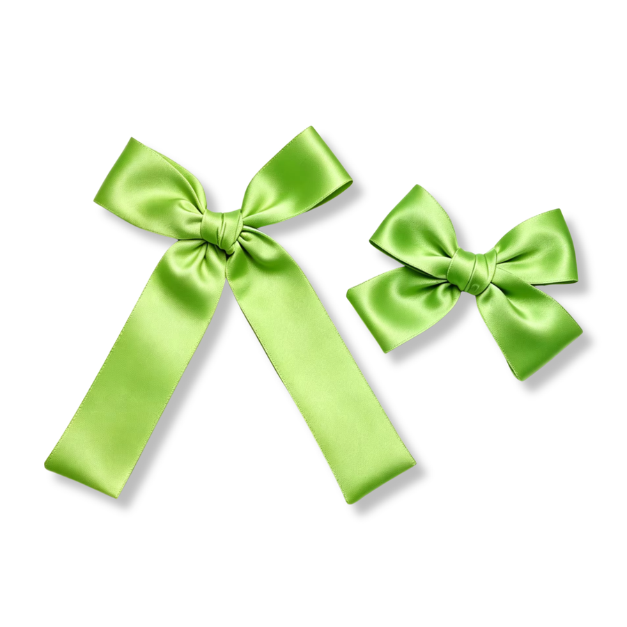This classic boutique bow is crafted from smooth satin ribbon in a vibrant lime green shade with a beautiful silky sheen. The design features elegantly folded loops and a neatly wrapped center knot, creating a timeless and versatile look. Shown in both large and mini sizes, the flowing tails and crisp structure make this bow perfect for everyday wear, holiday outfits, princess-inspired looks, and coordinating with themed accessories. 
Small Bow Sizing 4.5" x 4.5"
Large Bow Sizing 5.5" x 7"
