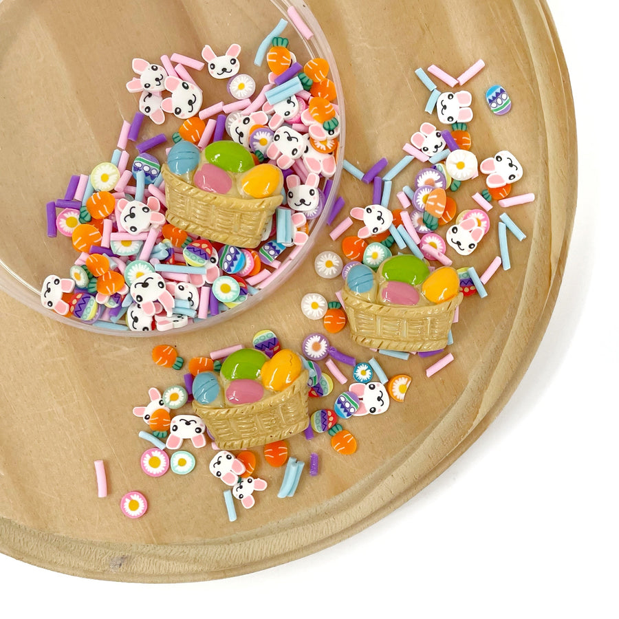 bunnies, sprinkles, daisies, carrots and plastic easter basket mixture.