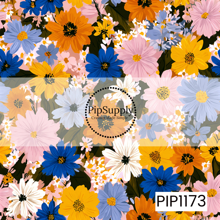 A vibrant wildflower pattern bursting with bold cobalt blue, golden yellow, orange, blush pink, soft periwinkle, and crisp white blooms layered over deep green foliage.
