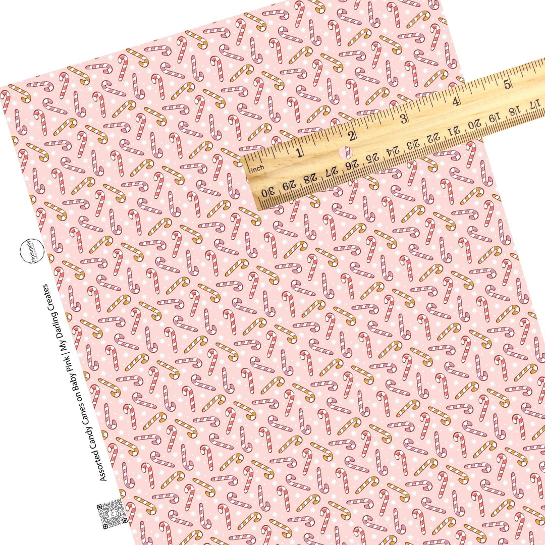 Assorted Candy Canes on Baby Pink Faux Leather Sheets