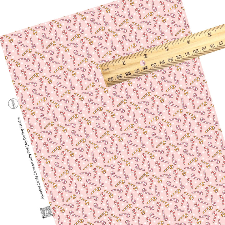 Assorted Candy Canes on Baby Pink Faux Leather Sheets