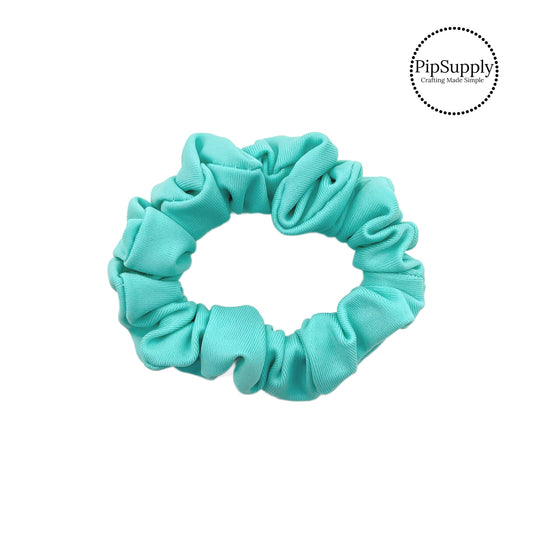 These aqua swim scrunchies have a two layer swimsuit fabric strip with edges that are securely folded and sewn providing a professional and high quality seam. Fabric is thick high quality not coarse or stiff with elastic band sewn inside for stretch-ability. Pattern visible on all sides. 