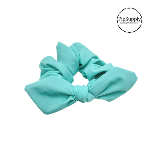 These aqua swim scrunchies have a two layer swimsuit fabric strip with edges that are securely folded and sewn providing a professional and high quality seam. Fabric is thick high quality not coarse or stiff with elastic band sewn inside for stretch-ability. Pattern visible on all sides. Bow comes pre-tied on scrunchie however is removable to be available as separate bow.