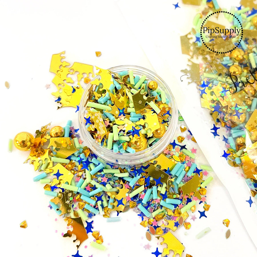 This princess inspired clay slice mix is versatile for many craft projects. This Arabian nights mix has gold crowns, gold pearls, blue sprinkles, and blue stars. You can use it to add sparkle and decoration to resin projects, filling for shaker bows, slime making, party decor, scrapbooking, card making and nail art.

This loose clay mix is sold in a resealable 1 oz Bag

- Material: Polymer Clay and Glitter