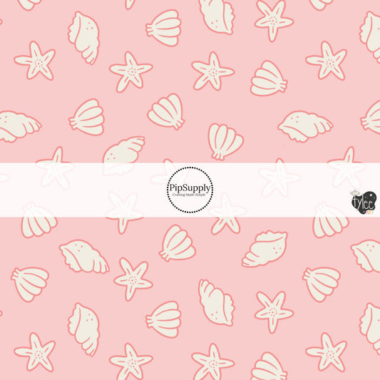 This beach fabric by the yard features seashells on light pink. This fun themed fabric can be used for all your sewing and crafting needs!