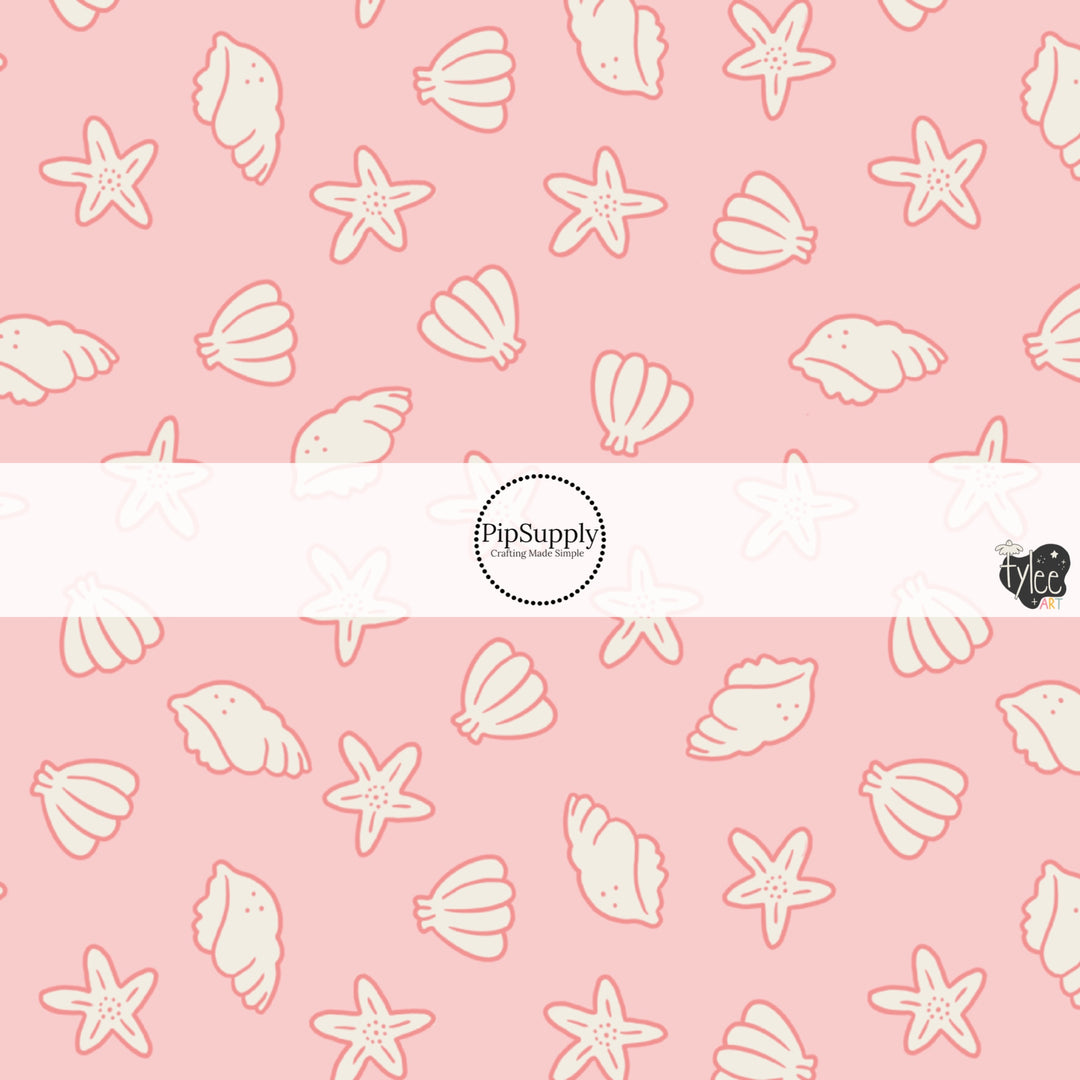 This beach fabric by the yard features seashells on light pink. This fun themed fabric can be used for all your sewing and crafting needs!