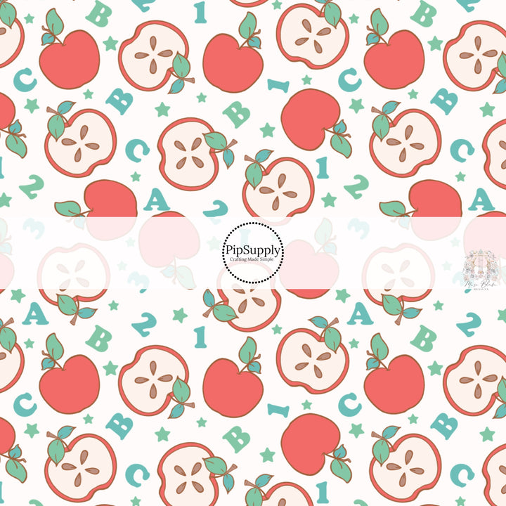 Cream fabric by the yard with apples, numbers, letters, and stars.