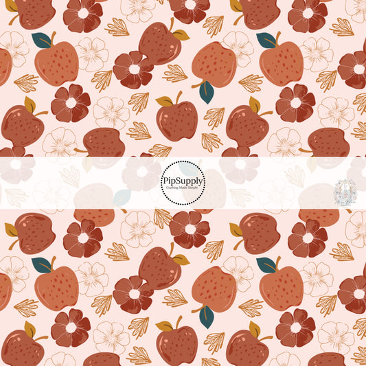 Light pink fabric by the yard with red apples and florals.