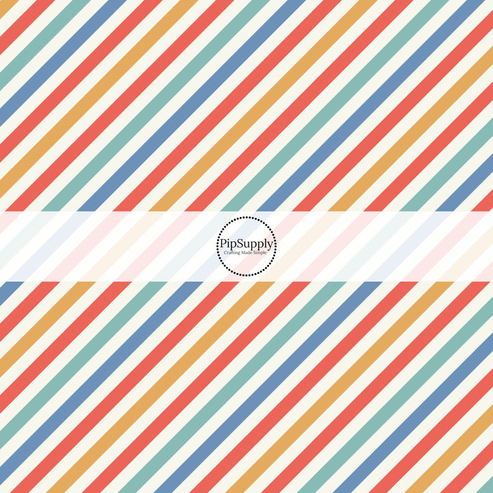 Red, yellow, blue, and aqua diagonal stripes on white fabric by the yard.