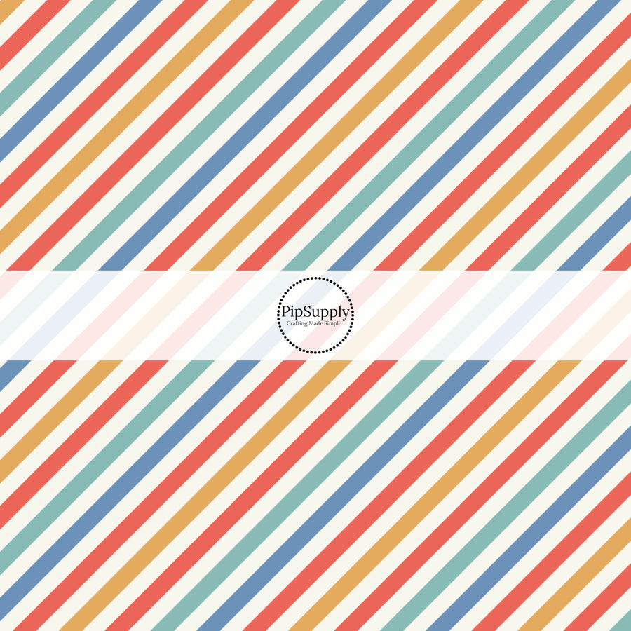 Red, yellow, blue, and aqua diagonal stripes on white fabric by the yard.