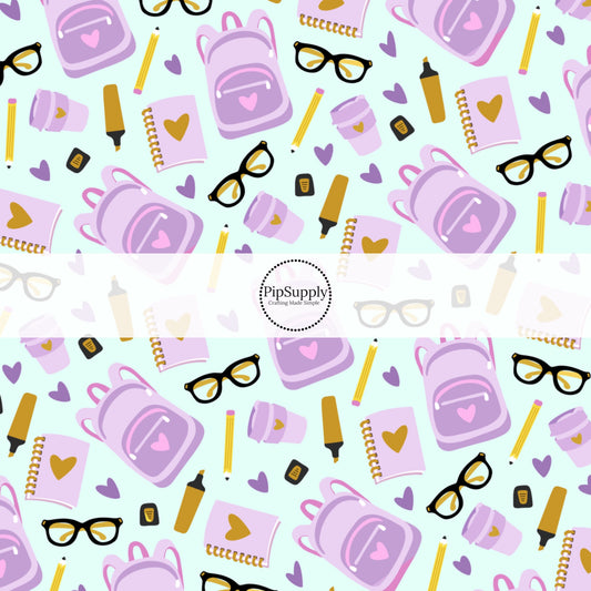 Aqua fabric by the yard with purple backpacks, yellow pencils, hearts, cups, and glasses.