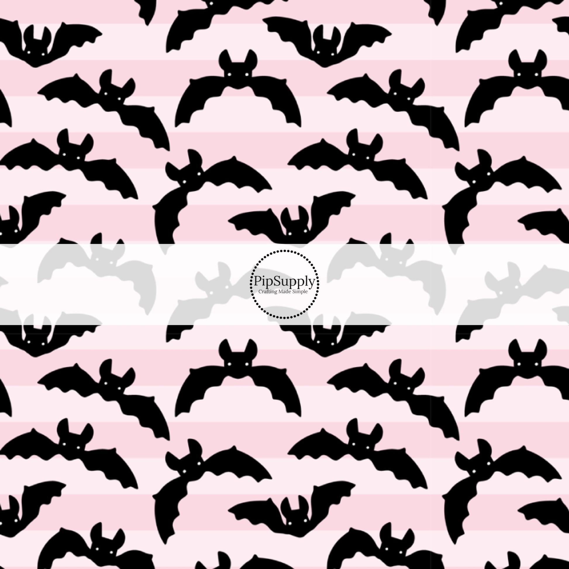Pink striped fabric by the yard with flying black bats.