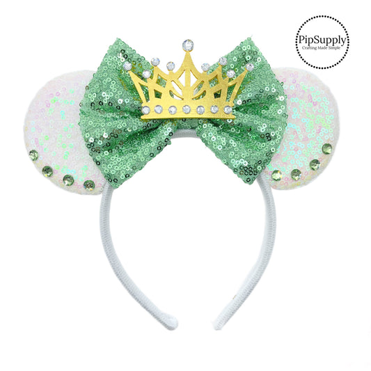 These beautiful mouse ear headbands are a stylish hair accessory. These comfortable headbands have an attached green glitter bow and white glitter mouse ears. Along with rhinestone and crown embellishment. This hair accessory comes completely assembled and is great for park vacations, costumes or for everyday wear!