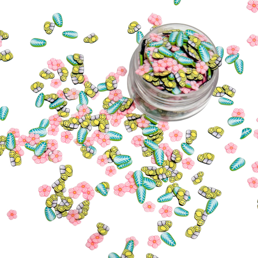 clay pieces made with bees, pink flowers and green leaves
This loose clay mix is sold in a resealable 1OZ Bag

- Material: Polymer Clay and Glitter
