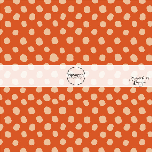 Rust orange fabric by the yard with beige speckled dots.