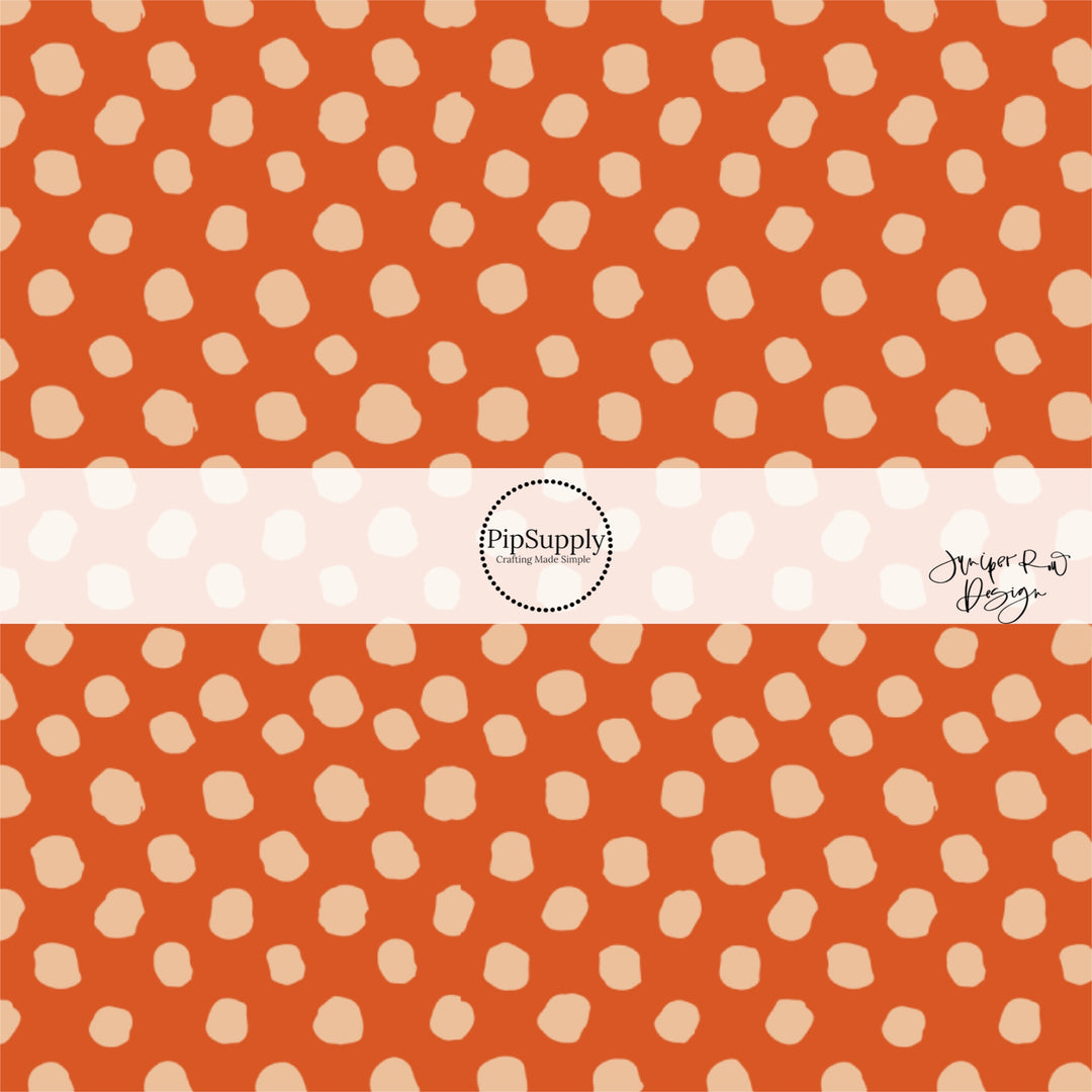 Rust orange fabric by the yard with beige speckled dots.