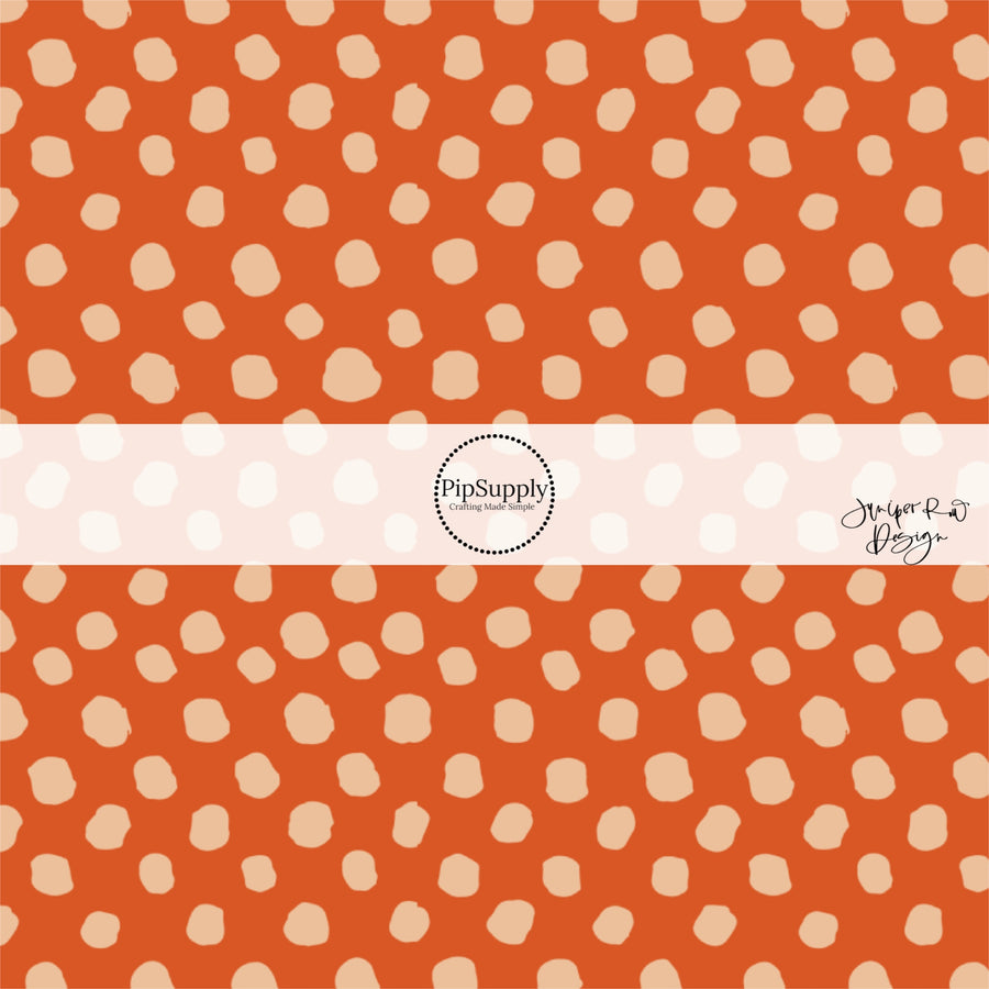 Rust orange fabric by the yard with beige speckled dots.