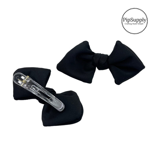 These black swim bows have a two layer swimsuit fabric bow with edges that are securely folded and sewn providing a professional and high quality seam. Fabric is thick high quality not coarse or stiff and the pattern is visible on all sides. Bow comes pre-tied on a clear plastic clip.