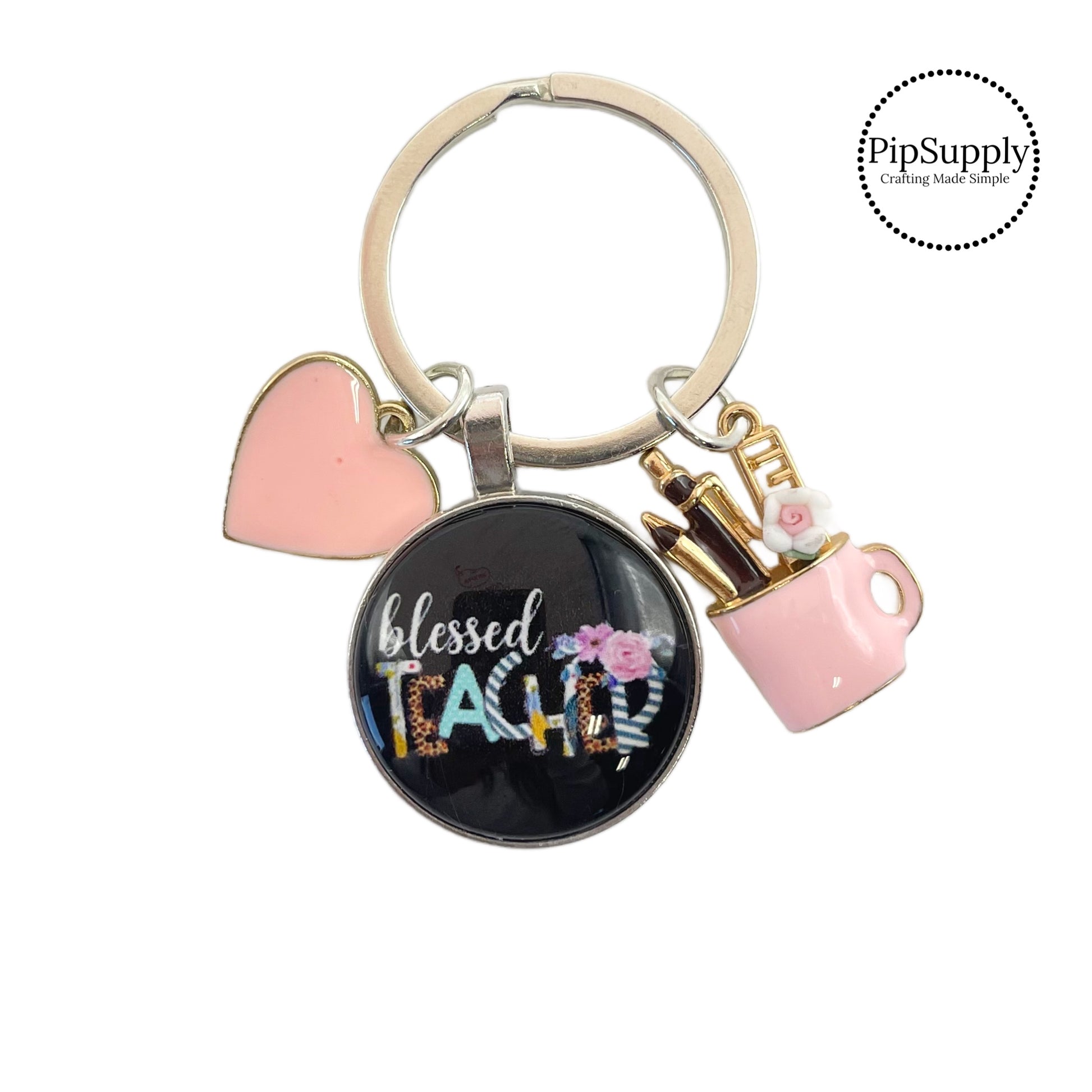 Pink heart charm, school supplies charm, and gratitude charm on a round silver keychain ring. The teacher appreciation charm has the following phrase: "Blessed Teacher." These silver key chains are perfect to add to your everyday key ring or give as a gift to a teacher!! These are ready to use or sell to others.
