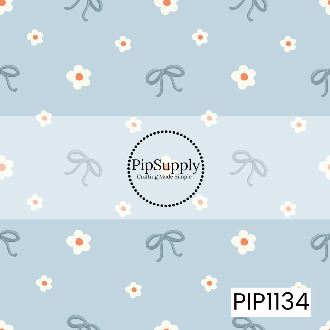 A sweet, airy pattern featuring dusty blue bows and scattered white flowers with coral centers on a soft powder-blue background.

